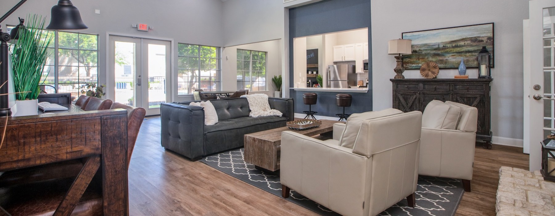 a clubroom with a couch, chairs and tables