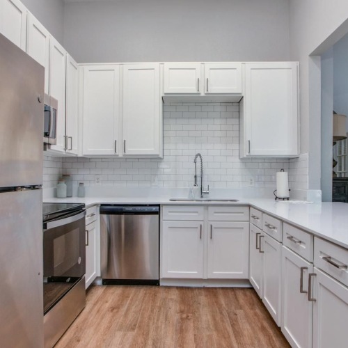 a kitchen with white cabinets