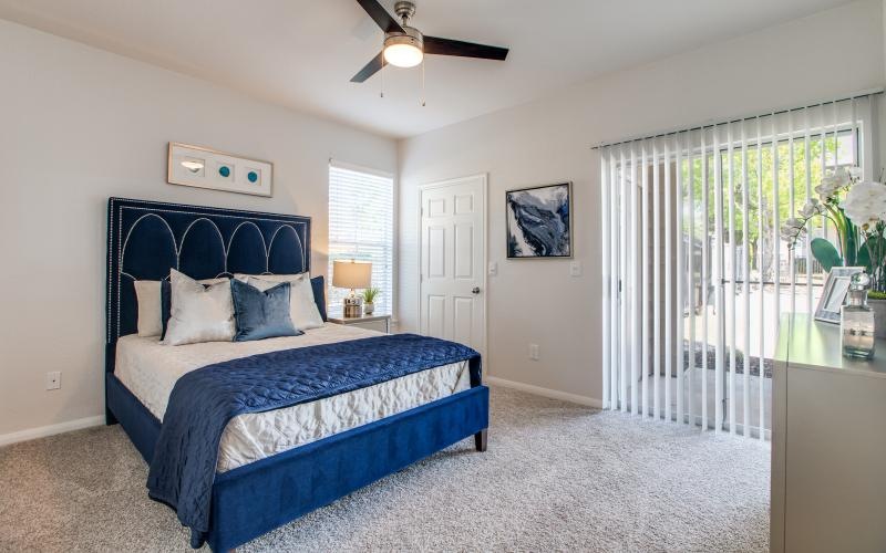 a bedroom with a bed and a fan