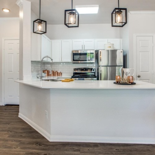 a kitchen with white cabinets