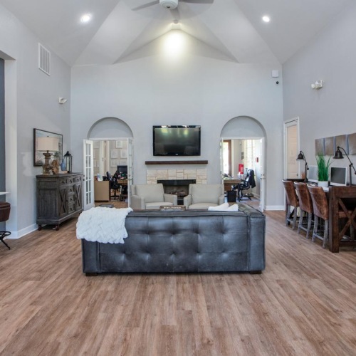 a clubroom with a tv and couches